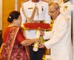 Kokilaben Ambani recieving Padam Shri award from President Pranab Mukherjee on 28th March 2016
